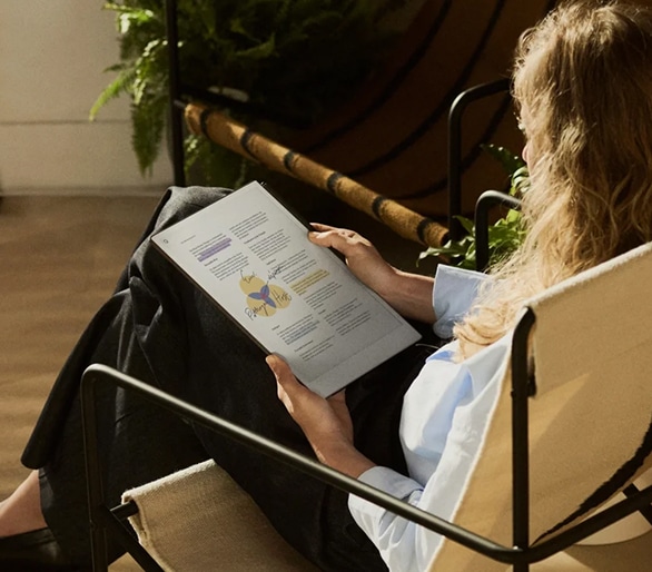 Picture → A woman reading a document that has been marked up and annotated with colored highlights on reMarkable Paper Pro.